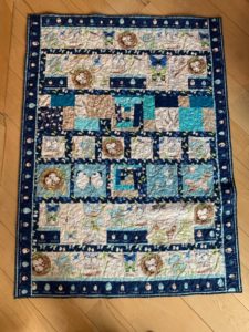 birds nest quilt with blues and browns